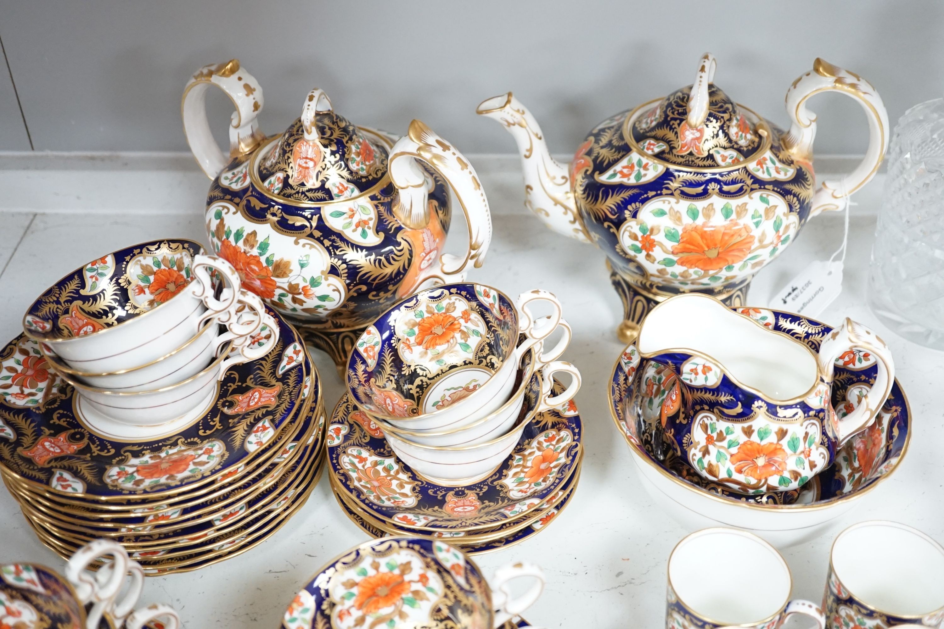 A mid 19th century English bone china fifty-two piece part tea and coffee service, decorated in an Imari pattern
